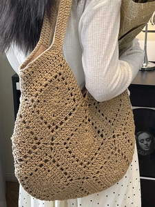 Handmade hollow woven crochet shoulder bag in beige for summer beach vacation