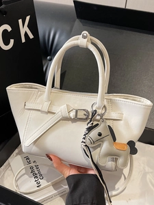 Elegant white trapezoid handbag with a horse charm and adjustable strap for women