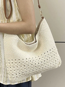 Minimalist beige crochet shoulder bag with brown leather straps and woven hollow pattern