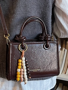 Dark brown pleated leather mini tote bag with colorful beads and gold logo detail
