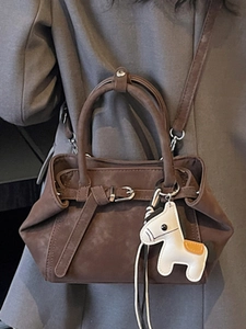 Brown frosted leather handbag with horse charm and adjustable strap for women