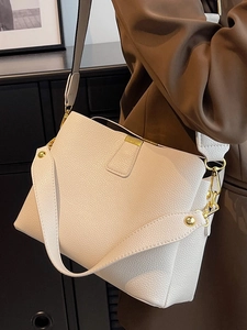 White lychee pattern leather bucket bag with gold hooks and wide shoulder strap