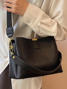 Chic black lychee leather bucket bag with gold hardware and dual shoulder straps for women
