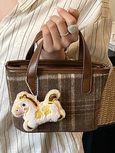 Brown plaid handbag with plush horse charm and leather handles for casual daily wear