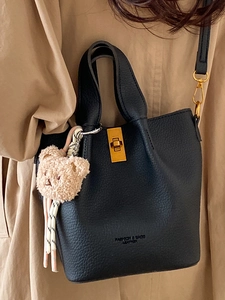 Sac seau classique en cuir noir avec ferrures dorées et charmant ours en peluche