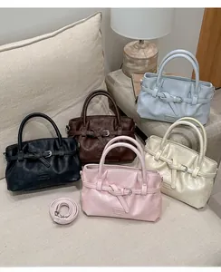 Detail showing various colors of PU leather bucket bags with pleated texture and buckle