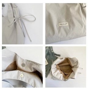 Detailaufnahme der Nylon-Tote-Bag mit silbernem Magnetverschluss und braunem Futter