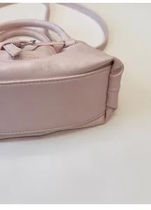 Detail of the pink leather bag base showing structured shape and fashion logo