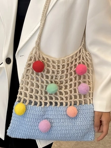 Knitted crochet tote bag with colorful pom-poms and blue patchwork design for women