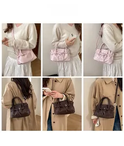 Pink and dark brown pleated bucket bags with decorative metal buckles and straps