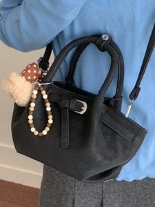 Chic black bucket bag with retro texture, mushroom charm and crossbody strap