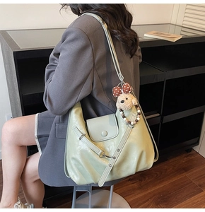 Detail of light green tote bag with matte PU texture and adjustable shoulder strap