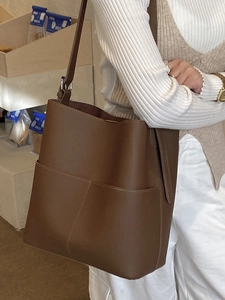 Dark brown leather bucket bag with lychee texture and large front pocket for women