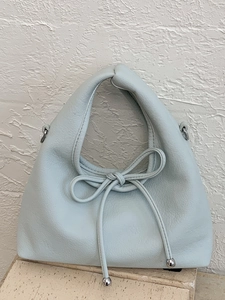Mint green pebble leather shoulder bag with decorative bow and silver metal details