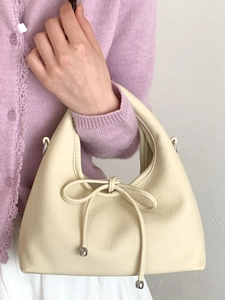 Minimalist beige leather shoulder bag for women with delicate bow and silver beads detail