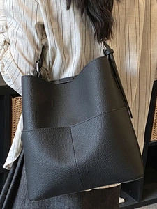 Classic black pebbled leather bucket bag with silver hardware for casual styling