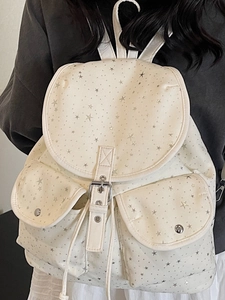 Sac à dos en toile blanche avec motifs d'étoiles argentées et deux poches avant