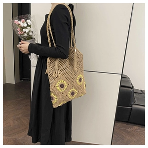 Détail du sac cabas au crochet à la main avec motifs de tournesols jaunes et pompon