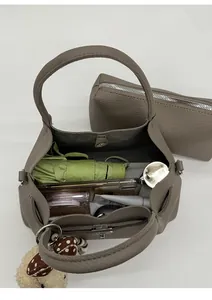 Vue de dessus d'un sac seau taupe en cuir grainé montrant sa grande capacité interne