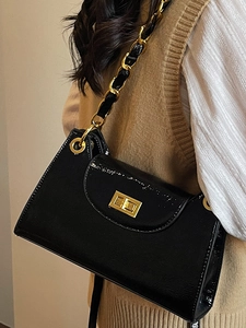 Retro black patent leather baguette bag with gold chain strap and metallic twist-lock