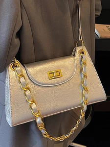 Silver metallic crossbody bag with gold chain strap and sleek turn-lock closure