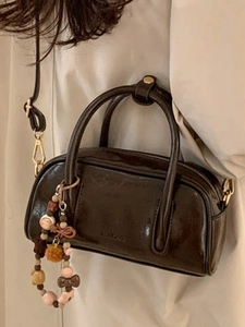 Classic dark brown Boston handbag with beaded charm and shoulder strap for women