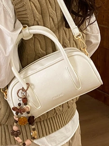 Elegant white Boston-style handbag with decorative beads and leather texture