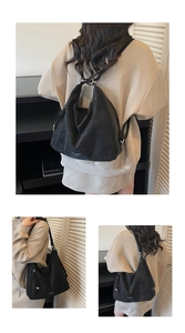 Detail of versatile black tote bag with adjustable straps for shoulder or crossbody wear