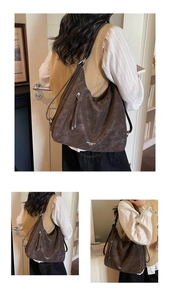 Detailed view of deep brown vintage tote bag with metal zipper and leather tassel details