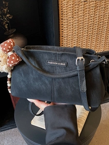 Large black matte faux leather shoulder bag with cute bow plush charm and adjustable strap