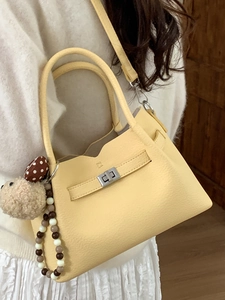 Sac seau en cuir jaune pâle avec poignée et bandoulière de forme trapèze classique