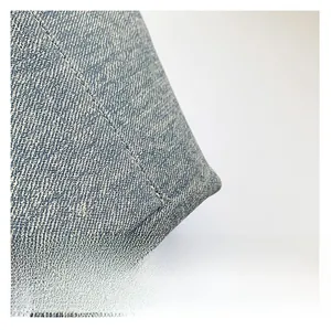 Close-up of blue denim tote bag showing twill texture and white stitching details