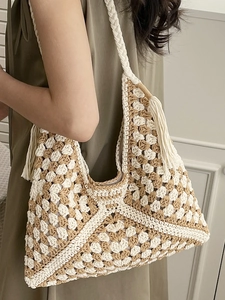 Large bohemian woven hobo bag with brown checkerboard pattern and fringe detail