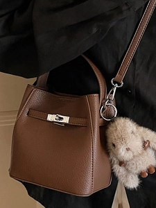 Dark brown leather bucket bag with silver buckle and cute pink rabbit keychain accessory
