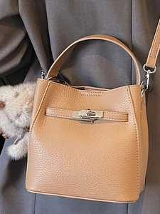 Fashionable apricot bucket bag in pebble leather with a cute plush bear charm