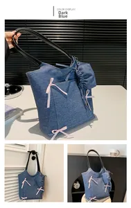 Detail view of navy denim tote bag with pink silk bows and small matching coin purse