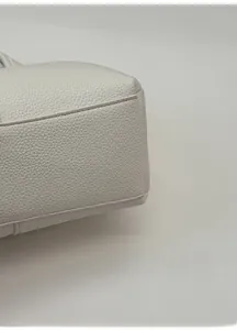 Detailed macro view showing the textured lychee pattern leather and reinforced wide base