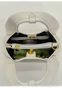 Top macro view of white pebble leather bag showing three compartments and large capacity