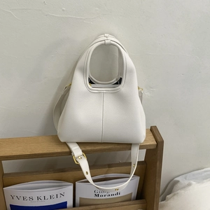 Close-up of white lychee grain leather bucket bag with golden hardware and strap