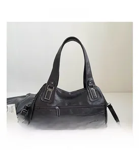 Detail view of large vintage brown handbag with unique safety pin zipper hardware and dual pockets