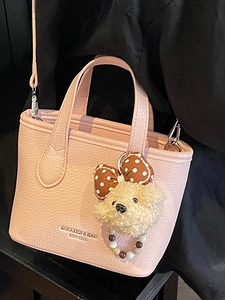 Chic pink lychee texture bucket bag with plush bear charm and detachable shoulder strap