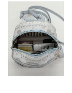 Internal view of a fashion mini backpack showing storage for phone and cosmetics