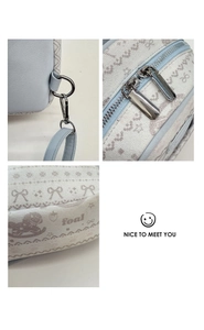 Detail of light blue leather and cream jacquard fabric with cute cartoon foal patterns
