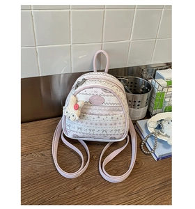 Detail of lavender mini backpack with floral patterns and a cute white bunny plush keychain