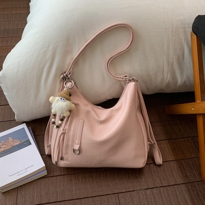 Pink faux leather hobo tote bag featuring a cute plush dwarf charm and metal hardware details