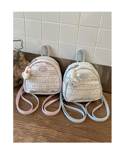Detail of pink and blue mini backpacks with cute prints and plush rabbit charms