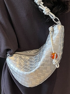 Silver metallic woven hobo shoulder bag with knot strap and decorative amber bead detail