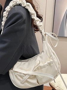 Chic cream white pleated shoulder bag with bow detail and glossy finish for women