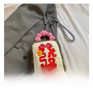 Close-up of creative plush toast-shaped bag with embroidery and pink handle