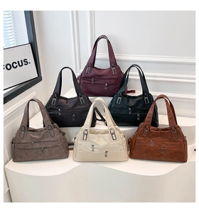 Multi-color collection of large capacity faux leather shoulder bags on a display stand